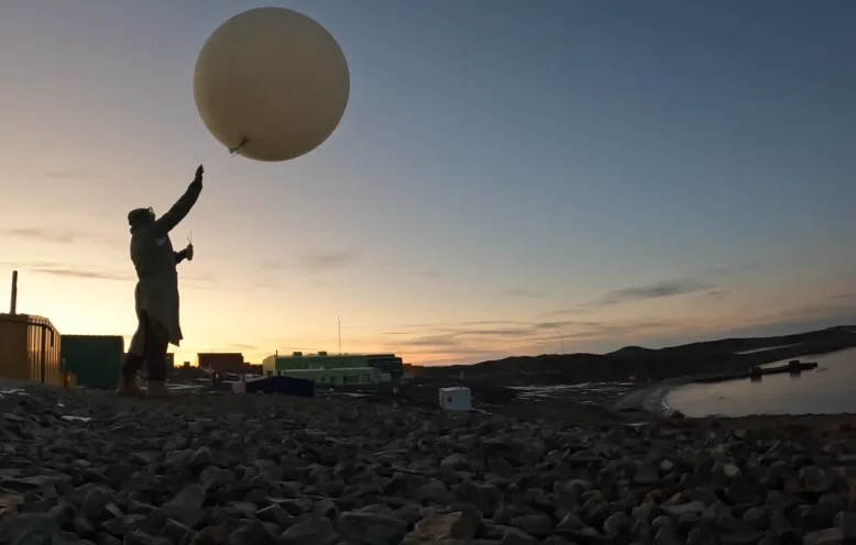 Weather observer releases weather balloon 