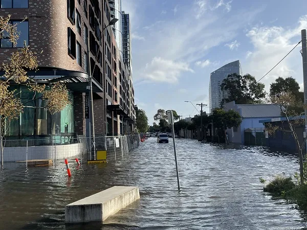 Floodwaters cover a city street.