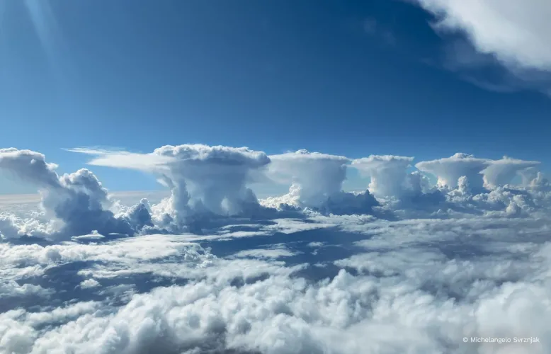 A line of thunderstorm clouds high in the sky